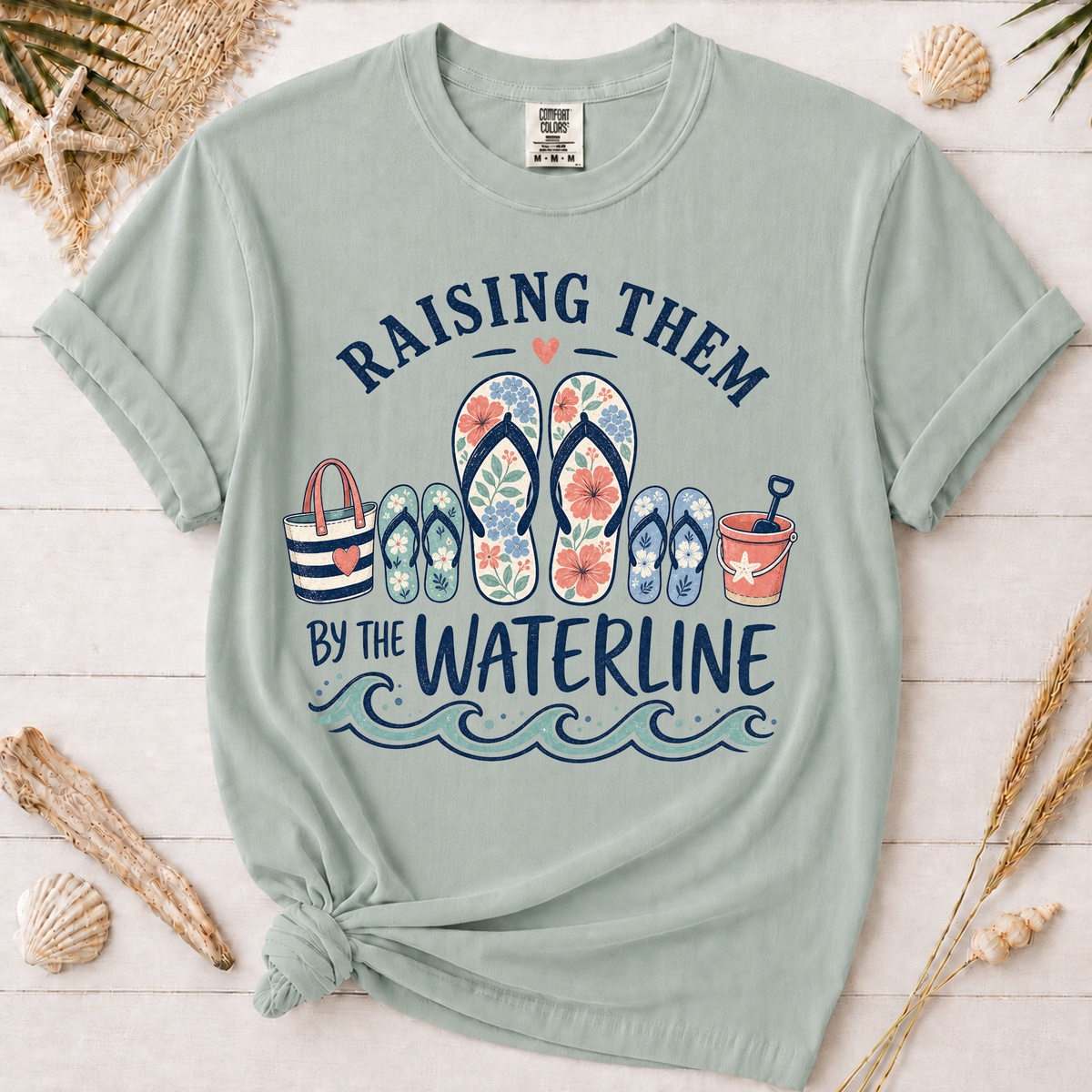 Raising Them by the Waterline Coastal Mom Graphic Tee