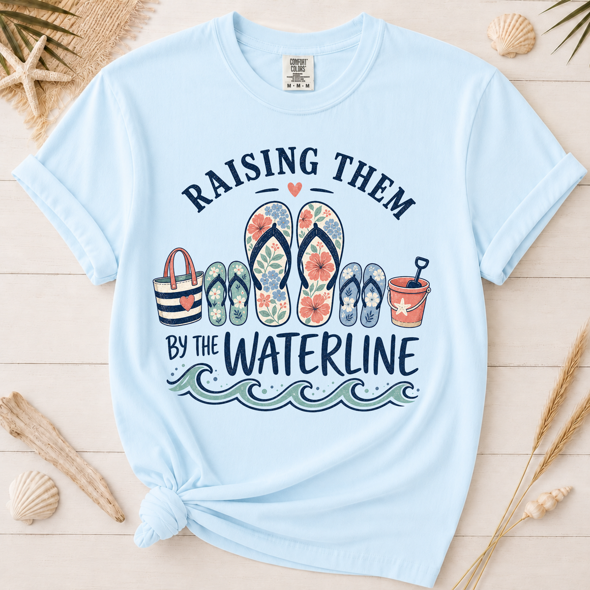 Raising Them by the Waterline Coastal Mom Graphic Tee