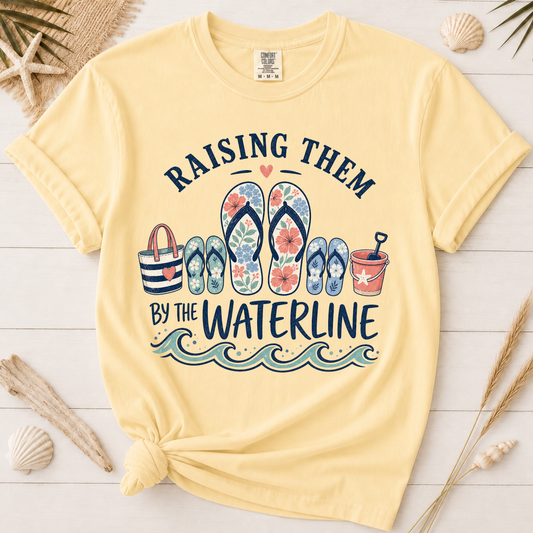 Raising Them by the Waterline Coastal Mom Graphic Tee